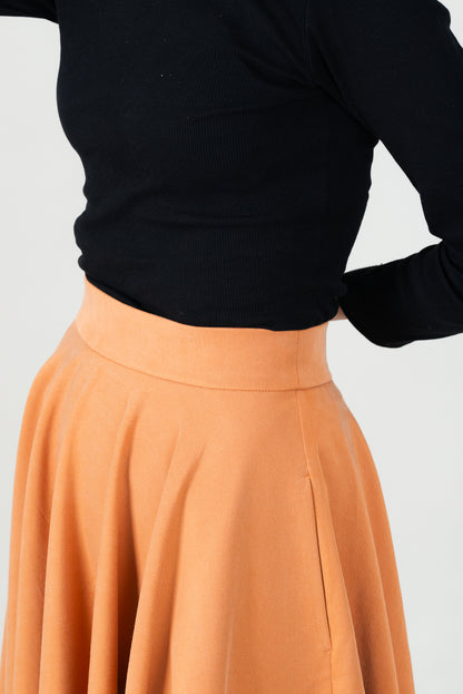 Frau in Tencel-Tellerrock Drehrock in der Farbe Karamell mit Taschen; Urheber: Mini & Eve